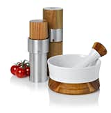 Stainless steel salt and pepper grinders and porcelain mortar and pestle set by Ad Hoc. The wooden accents on all pieces are acacia.