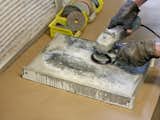 After a wet sanding, he polishes the slab starting with a 50-grit paper and moving all the way up to 300.
