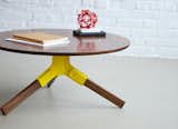 The walnut Conrad coffee table's legs snap into a stamped steel bracket, which comes in powder-coated black, ivory, or this sunny shade of yellow ($1,150).  Search “u trek coffee table” from New From Misewell