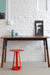 The walnut Grain desk ($1,775) and tomato-colored Sixagon stool ($350) are perfect companions. The Sixagon also works perfectly as a side table.  Adam Still’s Saves from New From Misewell