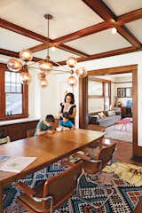 Dining Room, Table, Chair, Pendant Lighting, and Dark Hardwood Floor In the dining room, the vintage table and chairs are set off by a Modo Chandelier from Roll & Hill and a vibrantly patterned Anthropologie rug.  Photo 6 of 11 in An Airy Addition to a Historic Boise Home