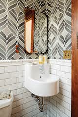 Bath Room, Wall Mount Sink, and Subway Tile Wall Playful wallpaper from Graham & Brown livens up the house’s otherwise staid 

powder room, which also contains a 

pint-size Ikea sink.  Photo 1 of 22 in 22 Powder Rooms That Pack Serious Style Into a Small Space from Wallpaper That Fixes Walls