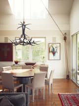 Paul painted the antler chandelier in the dining room, purchased from a friend in Alaska, glossy black. The pulley, selected from Paul’s growing collection, is fully functional. The custom-built dining table is ringed by Folio Leather side chairs 

from Crate & Barrel.