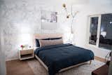 A BDDW furnished bedroom with custom Lindsey Adelman lighting.