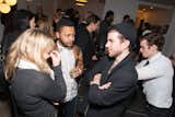 The Future Perfect gang share a drink as guests admire their handiwork.  Photo 4 of 14 in Dwell & DDG Holiday Party at 345meatpacking by Sara Carpenter