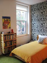 The children's bedroom features bright carpeting and patterned wallpaper.