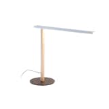 We love this lamp for its brilliant design features, including an etched lens that gently diffuses the light of its LED bulbs for comfortable task work. A single wooden dowel and metal base combine to create a clean and simple modern style statement.
