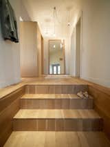 A stairway of white oak, oiled to impart a matte finish, leads into the apartment. The residents left the design decisions up to K-Studio, only requesting that the house have a "contemporary and calm" feeling.