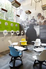 In the Center for Architecture’s double height gallery space, a grid of traditional school desks hang above a new, more flexible interpretation by Steelcase. There are also listening stations where visitors can hear the voices of 21st-century thinkers such as Katie Salen, James Paul Gee, and Howard Gardner, juxtaposed with key 20th century progressive educators whose contributions are listed behind.

Edgeless Schools takes into consideration how best to educate digital natives. “All these kids are growing up knowing they can access at a very young age the information of the world on a hand held device,” Mellin says. “What does that mean in terms of formal education? One thing that is agreed upon is that while no one knows how this will be played out, there is a great emphasis on flexibility, and being able to use spaces in a variety of ways.” Photo courtesy the Center for Architecture.  Photo 3 of 16 in Edgeless School: Design for Learning