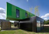 CG Architectes stacks two containers perpendicularly for this Brittany, France, house.
