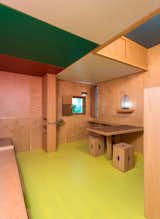 The built-in table and stools were crafted from used whiskey crates. The overhead cabinets provide additional storage so possessions are kept neatly out of sight in the small living space.  Photo 9 of 9 in Inside Le Corbusier's Le Cabanon at Art Basel/Design Miami by Sara Ost