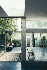 Once past the main threshold, the house opens up to the outside, literally and figuratively. Three courtyards built around existing trees flow seamlessly into a series of rooms with glazed walls and sliding glass doors.