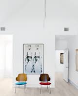 A pair of mid-century perches by Kofod-Larsen sit beneath a print by Andy Warhol in an upstairs bedroom.