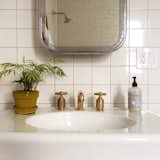 This satisfyingly spare bathroom features lovely brass hardware by Roman & Williams for Waterworks. This photo came to us from Instagram via @renamalka.