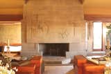 The Hollyhock House living room houses the original concrete block fireplace. The oversize wood furnishings were re-created from Wright's designs. The house was recently named a UNESCO World Heritage Site.  Photo 2 of 7 in Frank Lloyd Wright’s Hollyhock House Reopens After a $4.3 Million Restoration by Brandi Andres