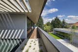 A second-floor balcony overlooks a landscaped garden and a 1,000-square-foot detached garage.  Photo 1 of 7 in Modern Stucco Homes by Aileen Kwun from A Plugged-In Home Rises in Prague