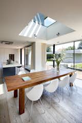 A skylight emphasizes the division of the upper level into master's and children's wings, and draws natural light deep into the core of the ground-floor kitchen and dining area.  Search “smart home” from A Plugged-In Home Rises in Prague