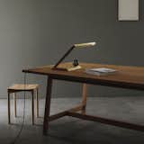 Designed by Nat Cheshire for Resident, the Oud Table Lamp is a versatile light that can be used as a desk light or as an accent lamp on a bedside table. Structured in a sharply angled, continuous line, the brass lamp conceals the mechanisms for the LED, making the light appear as if it is coming from the metal itself. The Oud diffuses warm light, and is operated by the crimson marble sphere at the lamp’s base.