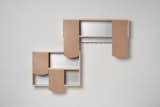 Shingle Shelves by German designer Hanna Kruger playfully suggest the act of opening and shutting cupboard doors—combinable rawhide modules act as sliding doors and overlap like shingles on a roof.