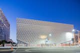 The museum’s “oculus,” the circular opening on the exterior veil, is a visual focal point at the heart of The Broad, where the collection storage vault resides. The vault is impressively protected by 36 million pounds of concrete. Beneath the 120,000-square-foot structure is a three-story parking garage, which will offer electric car charging stations and bike parking spaces. In addition to consideration of best green construction practices, the designers have also built the veil and vault with the potential threat of major earthquakes in mind.  Photo 6 of 6 in A Sneak Peek at the Broad Museum's Incredible Latticed Concrete Design by Brandi Andres