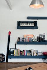 The upstairs living room open plan shelves hold an old Casio keyboard that belonged to Hart’s grandfather Pete.