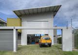 The slanted roof above the garage, painted white to reflect the heat in the tropical environment, also contains a solar heating system for water. The home also features a rainwater collection system, particularly useful during the long rainy season.