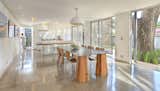 Dining Room, Concrete Floor, Table, Chair, and Pendant Lighting The kitchen, decorated with many of Pucci's prints, features a table Trejos designed.  Photo 11 of 11 in Who Knew a Relaxing Tropical Retreat Could Be Made of Shipping Containers by Patrick Sisson