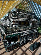 Architecture: Book Mountain, Spijkenisse, the NetherlandsFor optimum browsing, a veritable mountain of bookshelves created by MVRDV houses over a quarter mile of passages through the structure. Perched at the top is a reading room and cafe area with panoramic views through the transparent roof. Photo by Jeroen Musch.