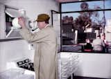 Here Monsieur Hulot (played by the film's director, Jacques Tati) rifles through a cupboard in the all-white kitchen. From Mon Oncle (1958), directed by Jacques Tati.