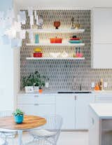 The space is just off the kitchen, which was moved and updated. Bradley paired cabinetry of his own design with rupee-shaped tiles from Heath Ceramics.