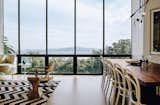 The living-dining room overlooks the neighborhood and the Bay beyond. The Safari chair was designed by Jens Quistgaard. Michael Thonet chairs are paired with a walnut table by Anthony Marschak for Original Timber Co.