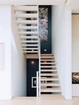 Staircase and Wood Tread Across from the entrance is the main staircase, which leads to the bedrooms.  Photo 8 of 19 in A Home with Eclectic Style Looks Just Right