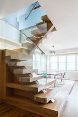 Reddy swapped out the spiral iron staircase for a modern wood one protected by glass walls.