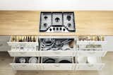 This kitchen system keeps everything organized with drawers for pots, knives, table linens, and dinnerware.