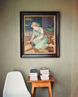 One of the bedrooms became a guest room and study, where a portrait of Green’s mother by Evelyn Spence-Reeve hangs above a vintage table.
