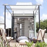 A wavy retractable awning structurally defines the outdoor space of this prefab pod concept in South Africa.