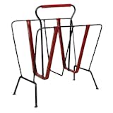 French designer Jacques Adnet (1904–1984) was particularly well known for his deft incorporation of leather elements into his furniture pieces. This rack, created sometime in the 1950s, is constructed of patinated wrought iron and delicately stitched red leather straps. For more information, contact Pascal Boyer Gallery.