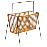 This circa-1950 wrought-iron-and-rattan rack was designed by American Industrial designer Tony Paul, who first garnered attention in 1940s New York for his metal-wire lighting and furniture pieces. For more information, contact Dual Modern.