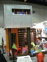 A corrugated-metal-clad children’s playhouse, designed by architect Jonathan Davis of pieceHomes, towered over the center of the Modern Family Zone.