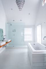 Whether it’s in the middle of the room or tucked away in a tiny corner, a bathtub is a key component of bathroom design.

Designer Tom Givone mixed a raw pine vanity with a sleek Produits Neptune Zen bathtub, clad in planks salvaged from the demolition of his previous home. Photo by Mark Mahaney