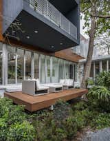 The cantilevered upper volume shades a deck on the ground floor.