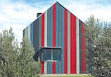 Neighbors surely can't miss the red-and-gray Vermont cladding from Everite’s Nutec line that makes this vacation home in South Africa an instant landmark (and a good deal warmer come winter) in a region full of rustic steel barns. “The color scheme pushes the envelope,” the owner says. “This town could do with some color.”