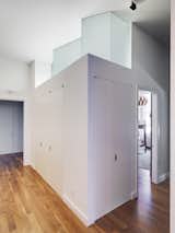 A serrated transom window above the closet in the children’s room floods the hallway with natural light. “By moving some closets and shrinking the size of the bedrooms, we were able to get three bedrooms out of two without taking away any floor space from the central living area,” Stageberg says. The closets feature extensive built-ins and the ceiling height helps the smaller rooms feel expansive.