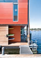 The exterior of a floating house in Seattle is clad with fiber cement panels from James Hardie painted in three slightly different hues: Fiery Opal, Navajo Red, and Rich Chestnut by Benjamin Moore.  Photo 2 of 3 in This Couple Merrily Floats Along in Seattle from How to Build a Floating Home