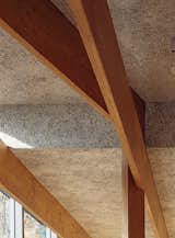 Wood-fiber cement panels by Koa Funen line the interior, and the criss-crossing laminated veneer lumber beams are from Key-Tec.