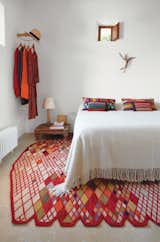 A peek inside the bedroom of designer Nani Marquina's Ibiza vacation home, featuring her own rug. (Pin)