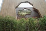 Another facade of the Ningbo Tengtou Pavilion shows another geometric cutout above a small forest of bamboo. Photo by Lu Wenyu courtesy of Amateur Architecture Studio.  Photo 4 of 7 in Pritzker Worthy: Awe-Inspiring Architecture by Pritzker Laureates by Luke Hopping