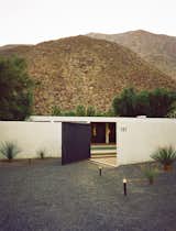 Doors and Exterior Architect Maurice McKenzie was inspired by symmetrical design, and the resulting linear and stark-white architecture makes a statement against the dry desert terrain. Photo by: JUCO  Photo 7 of 7 in Modern Getaways by Diana Budds from Photographer Q&A: JUCO