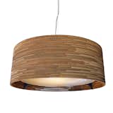 The Drum Scrap Light boasts a sturdy clear-coated steel frame, frosted-tempered-glass lens, handmade repurposed cardboard shade, and three light sockets inside. See more of this light here.