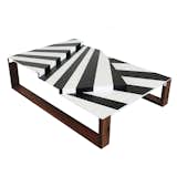 When painted large on the exterior of a warship, the graphic black-and-white stripes on this low table “dazzle” and confuse the eye of the enemy. Uhuru used teak from the deck of an authentic World War II vessel to create this coffee table inspired by the material’s storied nautical past.
